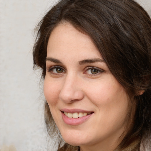 Joyful white adult female with long  brown hair and brown eyes