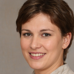 Joyful white young-adult female with medium  brown hair and brown eyes