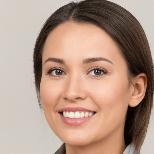 Joyful white young-adult female with medium  brown hair and brown eyes