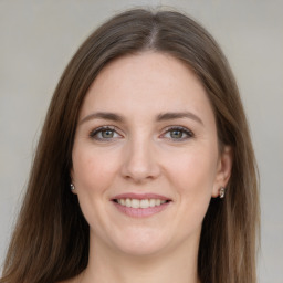 Joyful white young-adult female with long  brown hair and grey eyes