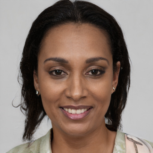 Joyful latino young-adult female with medium  brown hair and brown eyes