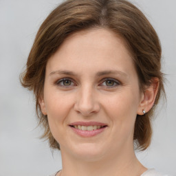 Joyful white young-adult female with medium  brown hair and green eyes