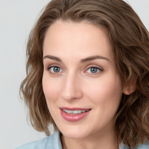 Joyful white young-adult female with medium  brown hair and blue eyes