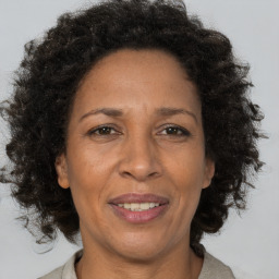 Joyful black adult female with short  brown hair and brown eyes