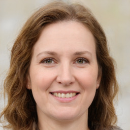 Joyful white young-adult female with medium  brown hair and green eyes