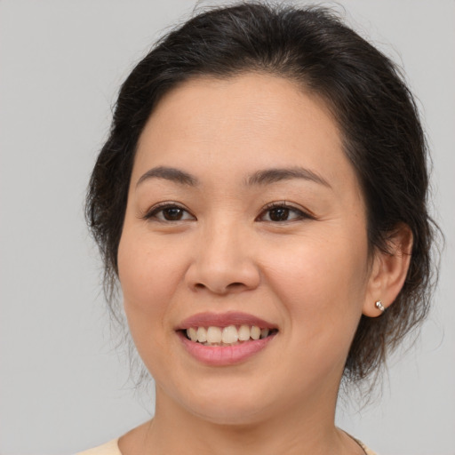 Joyful asian young-adult female with medium  brown hair and brown eyes
