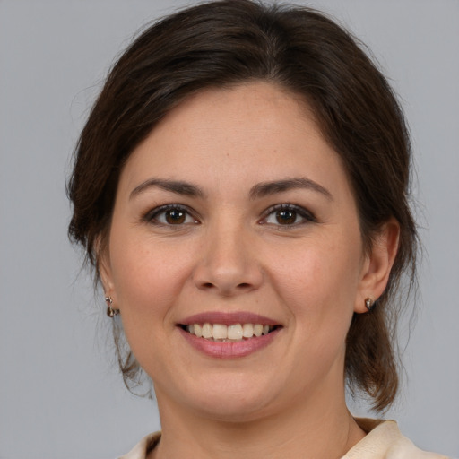 Joyful white young-adult female with medium  brown hair and brown eyes