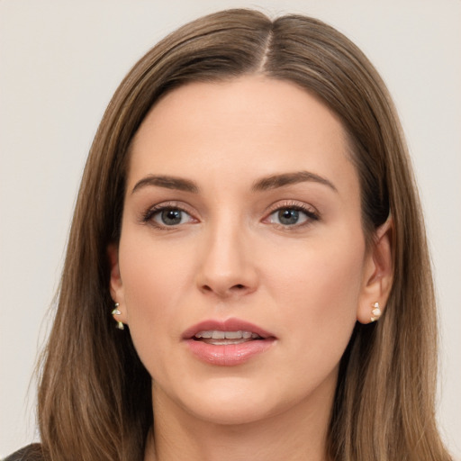 Joyful white young-adult female with long  brown hair and brown eyes