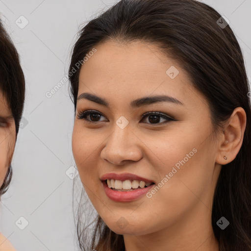 Joyful white young-adult female with long  brown hair and brown eyes