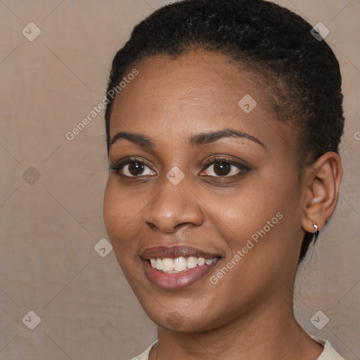 Joyful black young-adult female with short  brown hair and brown eyes