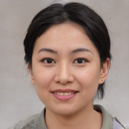 Joyful asian young-adult female with medium  brown hair and brown eyes