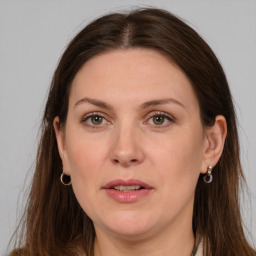 Joyful white adult female with long  brown hair and grey eyes