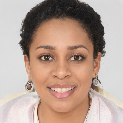 Joyful black young-adult female with short  brown hair and brown eyes