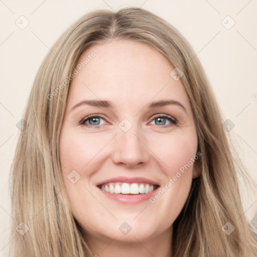 Joyful white young-adult female with long  brown hair and grey eyes