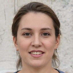 Joyful white young-adult female with medium  brown hair and grey eyes