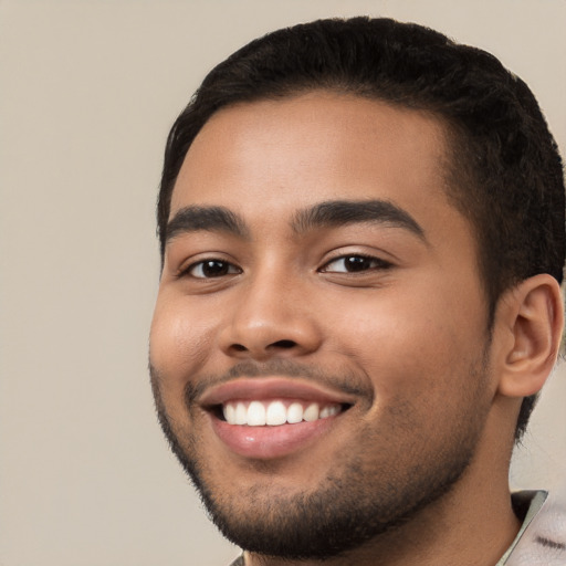 Joyful white young-adult male with short  black hair and brown eyes