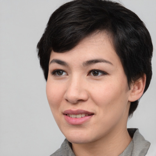 Joyful asian young-adult female with medium  black hair and brown eyes
