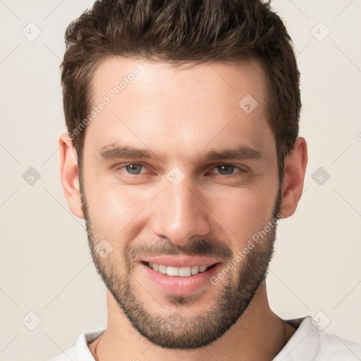 Joyful white young-adult male with short  brown hair and brown eyes