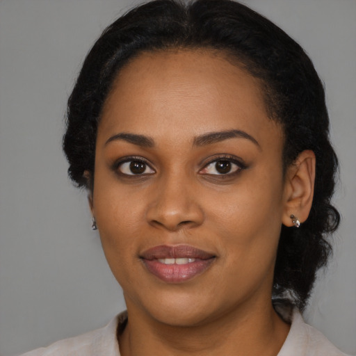 Joyful black young-adult female with medium  black hair and brown eyes