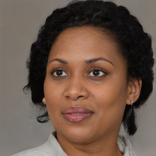 Joyful black adult female with medium  black hair and brown eyes