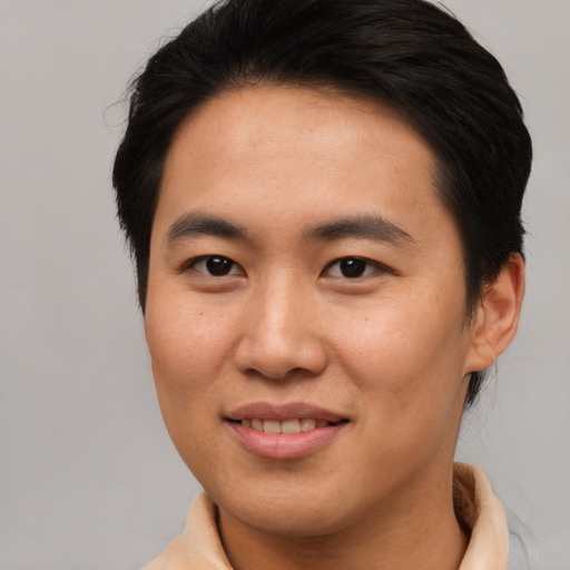 Joyful asian young-adult male with medium  brown hair and brown eyes