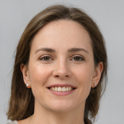 Joyful white young-adult female with medium  brown hair and grey eyes