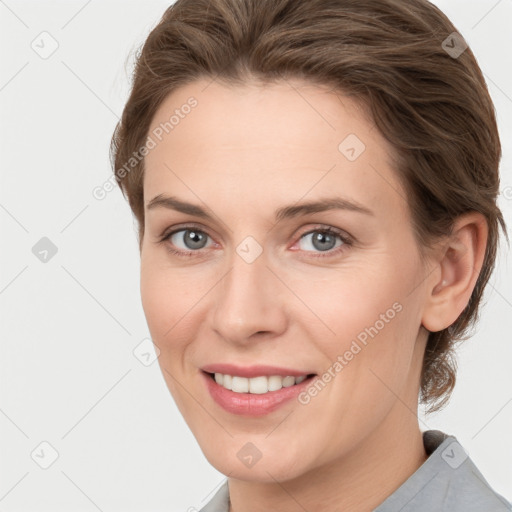 Joyful white young-adult female with short  brown hair and grey eyes