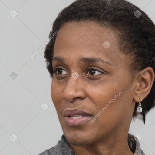 Joyful black adult female with short  black hair and brown eyes