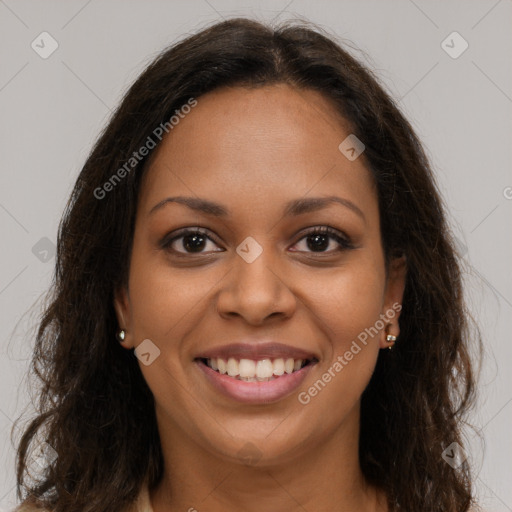 Joyful black young-adult female with long  brown hair and brown eyes