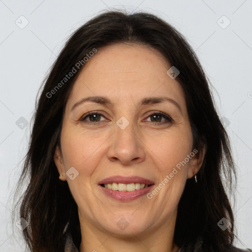 Joyful white adult female with long  brown hair and brown eyes