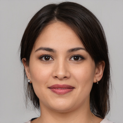 Joyful white young-adult female with medium  brown hair and brown eyes