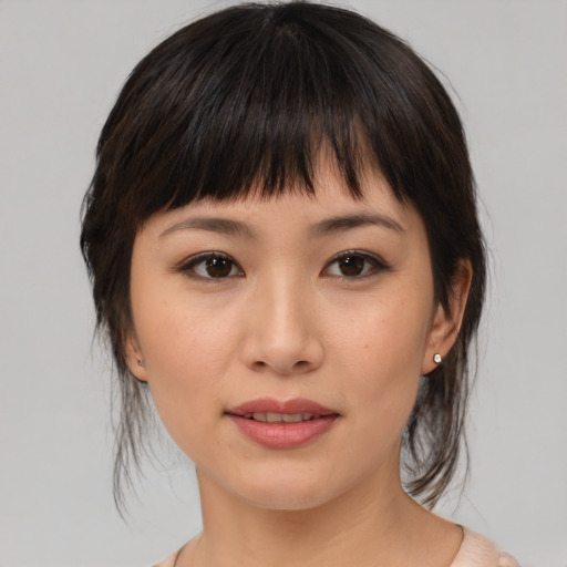 Joyful asian young-adult female with medium  brown hair and brown eyes