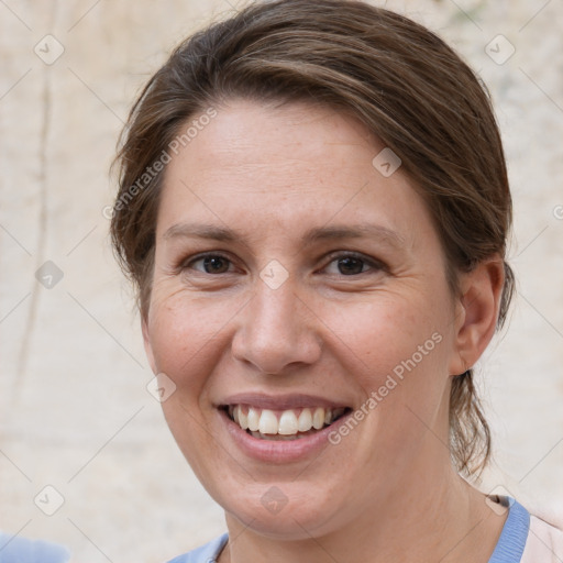 Joyful white adult female with medium  brown hair and grey eyes