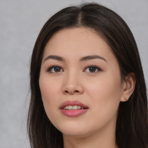 Joyful asian young-adult female with long  brown hair and brown eyes