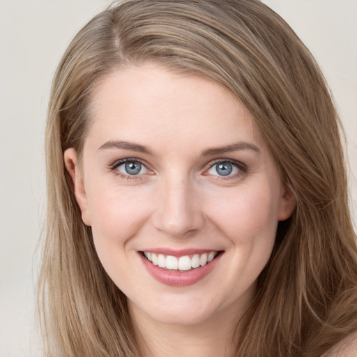 Joyful white young-adult female with long  brown hair and grey eyes