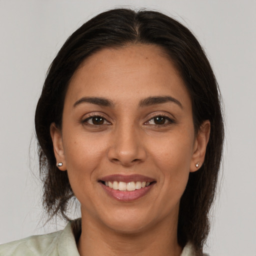 Joyful white young-adult female with medium  brown hair and brown eyes