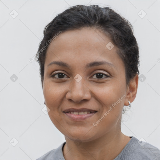 Joyful latino young-adult female with short  brown hair and brown eyes