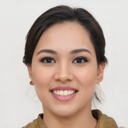 Joyful asian young-adult female with medium  brown hair and brown eyes