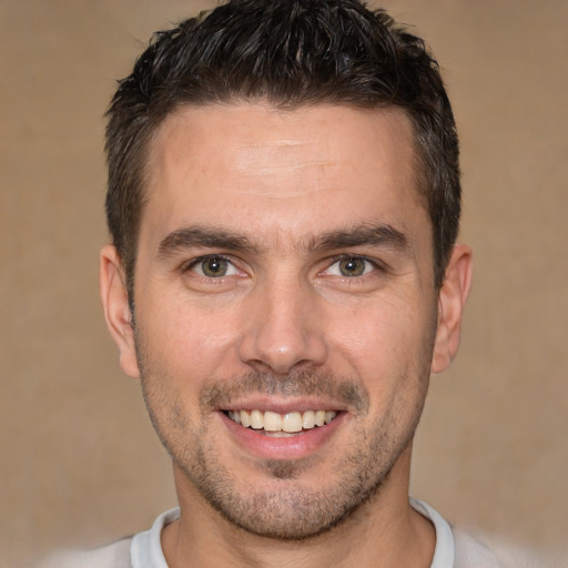 Joyful white young-adult male with short  brown hair and brown eyes