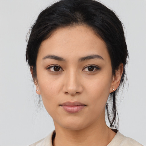 Joyful asian young-adult female with medium  black hair and brown eyes