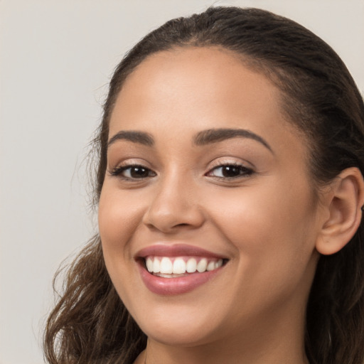 Joyful white young-adult female with long  brown hair and brown eyes