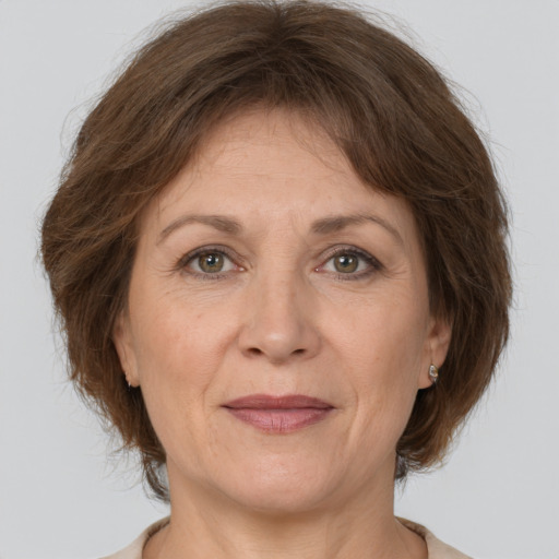 Joyful white adult female with medium  brown hair and brown eyes