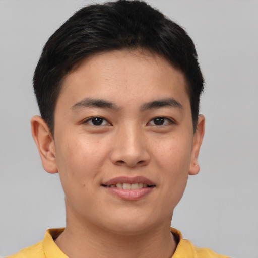 Joyful asian young-adult male with short  brown hair and brown eyes