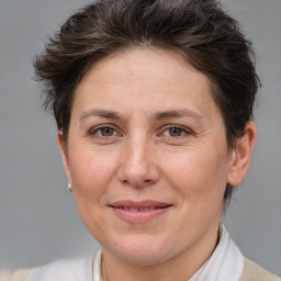 Joyful white adult female with short  brown hair and brown eyes