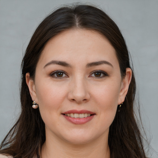 Joyful white young-adult female with long  brown hair and brown eyes