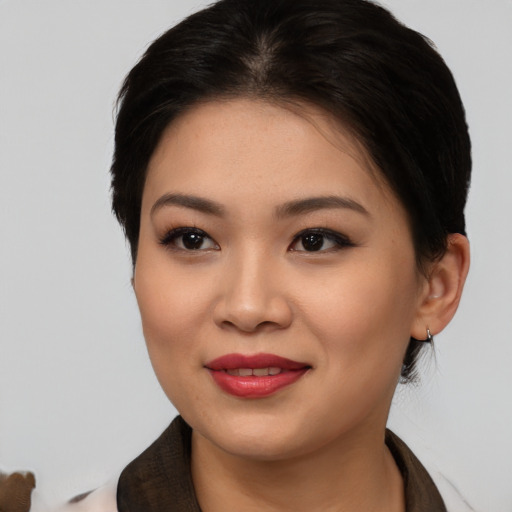 Joyful asian young-adult female with medium  brown hair and brown eyes