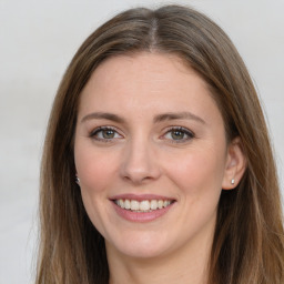 Joyful white young-adult female with long  brown hair and grey eyes