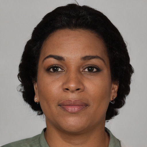 Joyful black adult female with short  brown hair and brown eyes