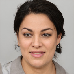 Joyful white young-adult female with medium  brown hair and brown eyes