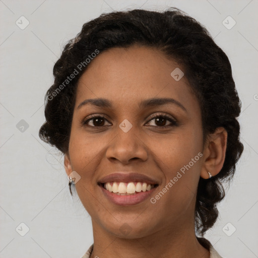 Joyful black young-adult female with medium  brown hair and brown eyes